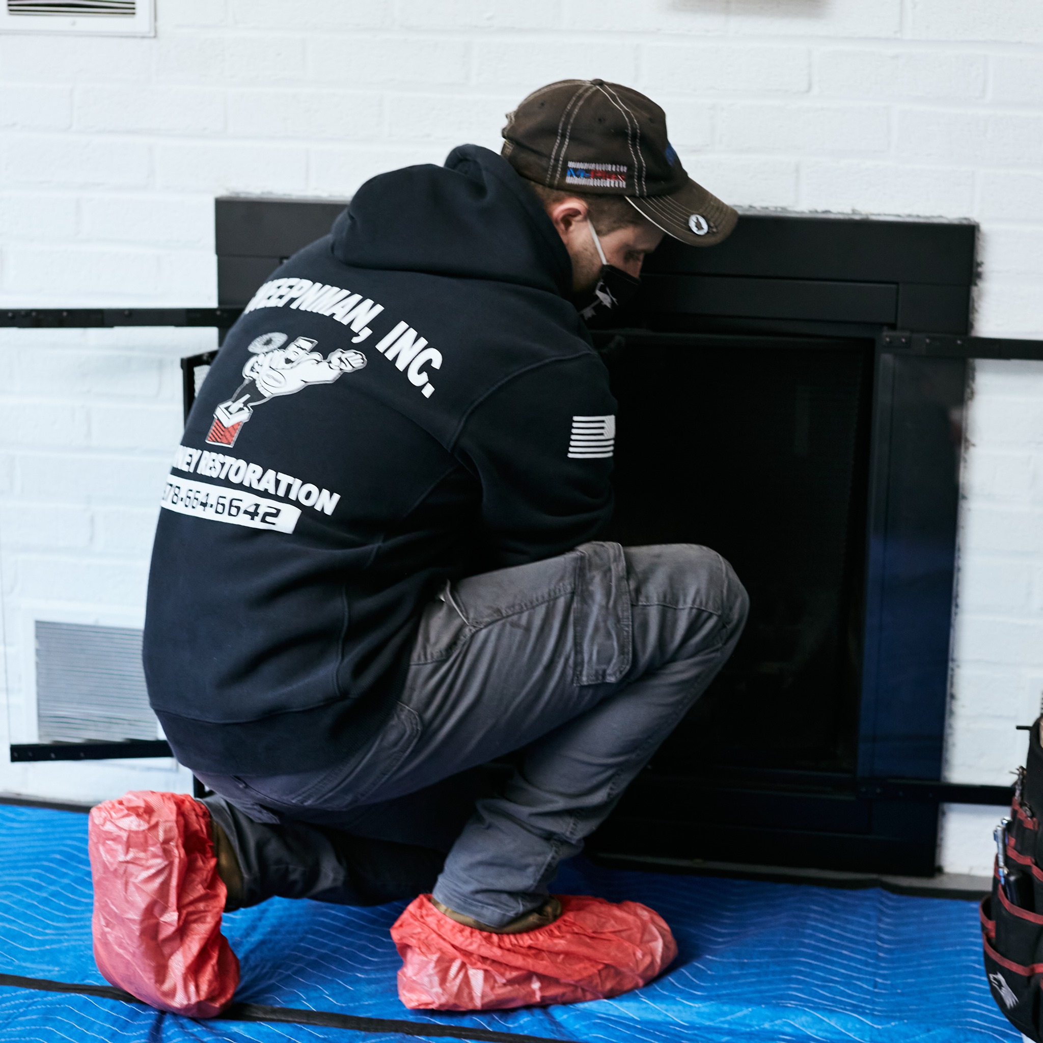 Technician inspecting fireplace