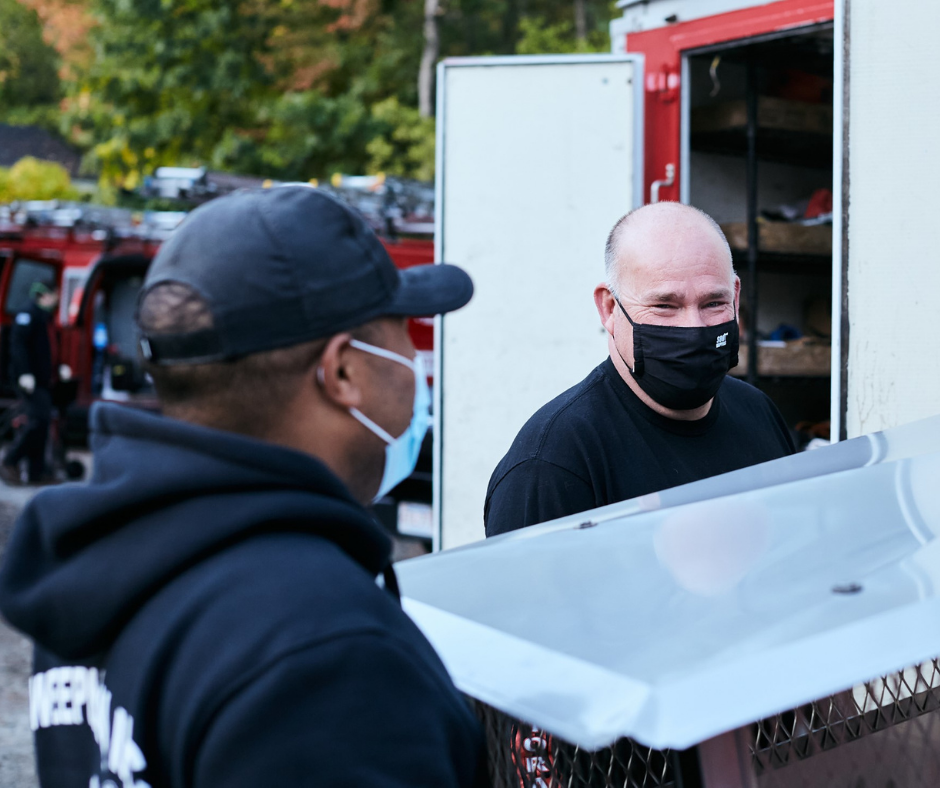 Technicians carrying chimney cap