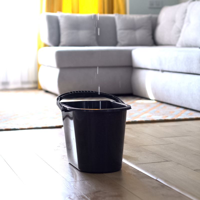 water inside a living room dripping into a black bucket<br />
